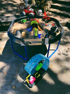 a wheelbarrow filled with toys sitting on the ground