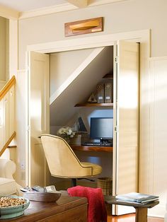 an open door leading to a living room with a computer on the table and other furniture