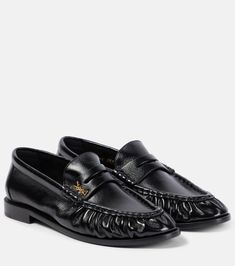 Le Loafer leather loafers in black - Saint Laurent | Mytheresa Luxury Black Loafers, Luxury Moc Toe Loafers For Galas, Luxury Oxford Loafers For Formal Occasions, Luxury Formal Dress Shoes With Lug Sole, Luxury Loafers With Lug Sole And Moc Toe, Luxury Loafers With Metal Feet For Party, Luxury Tassel Loafers With Round Toe For Galas, Luxury Semi-formal Leather Shoes With Textured Sole, Luxury Women's Wingtip Loafers