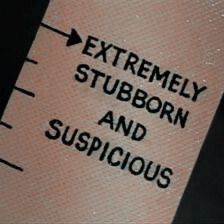 an extremely stubborn and suspicious label on the side of a shirt that says, extremely stubborn and suspicious