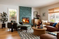 a living room filled with furniture and a fire place in the middle of the room