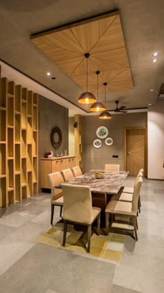 a large dining room table and chairs with wooden shelves