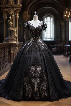 a black and white wedding dress on display in a room with wooden floors, chandeliers