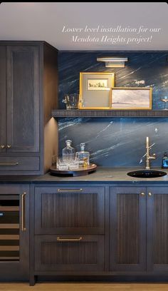 a kitchen with marble counter tops and wooden cabinets in front of a blue wall that reads lower level installation for our meridian heritage project