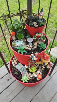 three tiered planter filled with plants and rocks