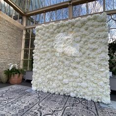 a large white flower covered wall in front of a window