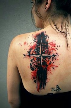 a woman with a cross tattoo on her back