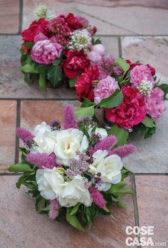 two bouquets of flowers sitting on the ground