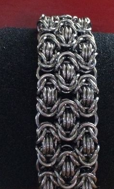 "This handmade chainmaille bracelet is made from heavy stainless steel rings forming the tri- Byzantine chainmaille weave to form a wide cuff bracelet with a sturdy toggle clasp. The bracelet material is slightly heavier than others due to the material that I use but it is very flexible and fluid like and feels fantastic on the wrist. I prefer stainless steel to many other metals because they're sturdy they don't fade and they don't tarnish and they have that oxidized shade instead of being shin Chainmaille Clothing, Chainmaille Weaves, Byzantine Chainmaille, Chainmaille Jewelry Patterns, Chain Maille Patterns, Chainmail Patterns, Chainmail Necklace, Chainmail Bracelet, Chainmail Jewelry