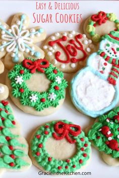 decorated sugar cookies on a plate with the words easy and delicious sugar cookies written in red