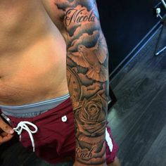 a man's arm with a clock and roses tattoo on the left side of his right arm