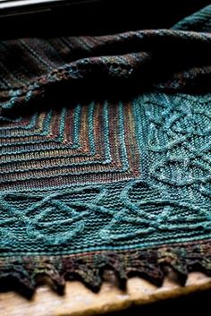 a close up of a blanket on top of a wooden table