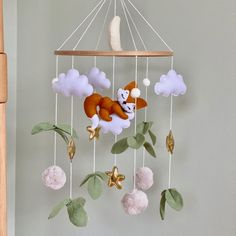 🦊 Adorable Sleepy Fox Baby Crib Mobile - Handcrafted with Love Lull your little one to sleep with the charm of our handmade felt baby crib mobile featuring a sweet orange fox nestled on a fluffy white cloud. This whimsical mobile is the perfect addition to any nursery, adding a touch of enchantment and sophistication. Key Features: 🍃 Nature-Inspired Design: The mobile is adorned with lush green leaf vines and delicate gold stars, creating a serene and dreamy atmosphere for your baby. 🌿 Premiu Whimsical Mobile, Fox Baby Nursery, Fox Felt, Boy Baby Shower Gift, Woodland Crib, Cot Toys, Baby Mobile Felt, Dreamy Atmosphere, Fox Nursery