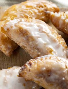 glazed donuts with icing on a wooden surface