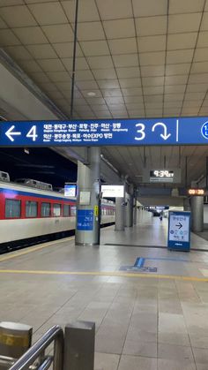 an empty train station with two trains on the tracks