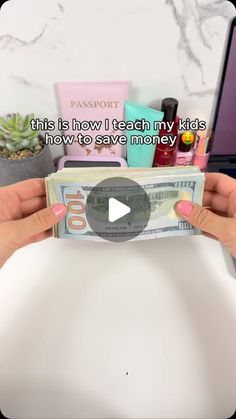 a person holding up a money bill with the words, this is how i teach my kids how to save money