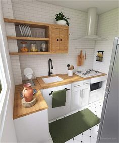 a small kitchen with white tile and wooden counter tops, green mats on the floor