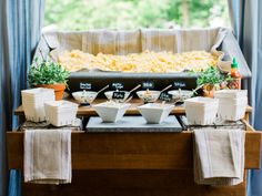 a buffet table set up with food and drinks on it for a wedding or bridal party