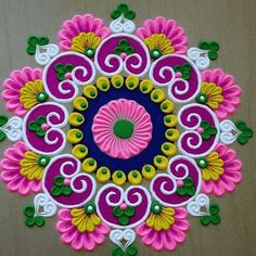 a colorful flower design on a wooden surface