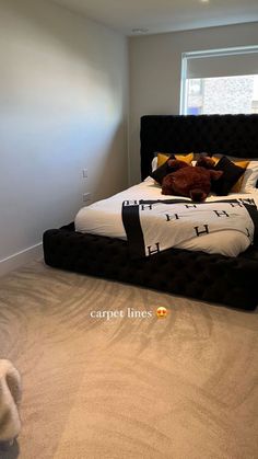 a bedroom with carpeted flooring and a bed in the middle of the room