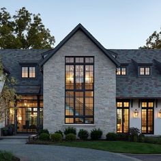 a large white brick house with lots of windows