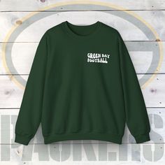 This Green Bay unisex heavy blend crewneck sweatshirt is pure comfort. These garments are made from polyester and cotton. This combination helps designs come out looking fresh and beautiful. The collar is ribbed knit, so it retains its shape even after washing. There are no itchy side seams on these sweaters. .: Made using 100% ethically grown US cotton. Gildan is also a proud member of the US Cotton Trust Protocol ensuring ethical and sustainable means of production. The blank shirt's dyes are Green Fan Apparel Sweatshirt, Green Crew Neck Sweater With Screen Print, Green Sweatshirt For Streetwear, Green Crew Neck Sweater With Letter Print, Green Letter Print Crew Sweater, Green Crew Sweatshirt With Screen Print, Green Crew Neck Sweatshirt With Screen Print, Green Crew Neck Fleece Sweatshirt, Green Fleece Crew Neck Sweatshirt