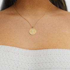 Give your Greek jewelry stack a dose of texture with the engraved Greek Lord's Prayer (Πάτερ Ημών) disc necklace. This unexpected design features a round pendant engraved with the words of the Lord's Prayer in Greek. A cross cutout in the center completes the design, which comes on a delicate and layerable chain.