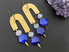 This earring consists of geometric brass findings paired with lapis lazuli and chocolate moonstone stones. The total length of the earrings is around 2.25 inches from the ear lobe. The components here is made of brass . Beautiful gemstones is suspended from the body. Your earrings will come in a box ready for gifting.Let me know if you have any questions. Geometric Brass Earrings For Gift, Modern Blue Brass Earrings, Nickel-free Geometric Brass Earrings, Handmade Blue Geometric Earrings, Minimalist Blue Brass Earrings, Handmade Blue Geometric Jewelry, Handmade Brass Dangle Linear Earrings, Minimalist Brass Earrings With Natural Stones, Handmade Modern Brass Earrings