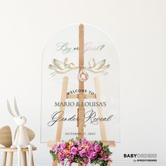 a wooden easel with flowers in it next to a sign that says welcome to mario & lousiana's grand resort