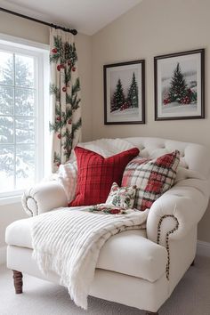 a living room with white furniture and christmas decorations on the window sill in front of two windows