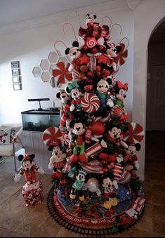 a christmas tree decorated with mickey mouses and candy canes