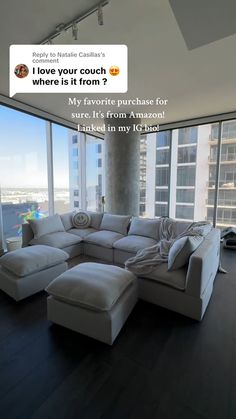 a living room filled with furniture next to large windows and a floor to ceiling window