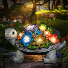 a turtle statue with flowers on its back