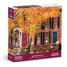 a puzzle box with an image of a house on the front and fall foliage in the background