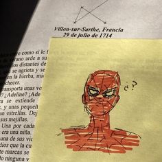 a piece of paper with a drawing of a man's face on top of it