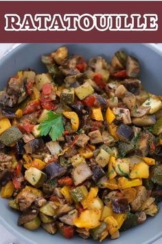 a blue bowl filled with cooked vegetables and garnished with parsley on top