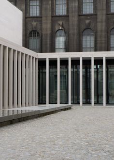 an empty courtyard with columns and windows