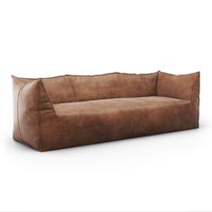 a brown leather couch sitting on top of a white floor