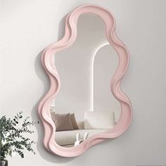 a mirror that is on the wall next to a couch