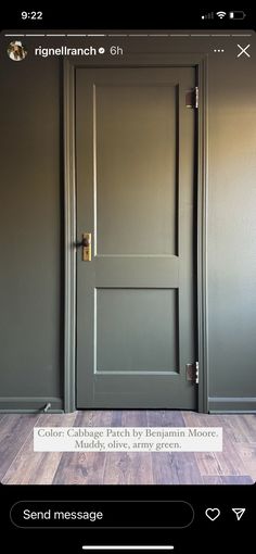 an open door in a room with wood flooring and gray paint on the walls