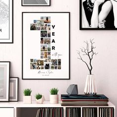 there are many pictures hanging on the wall next to some books and vases with plants in them