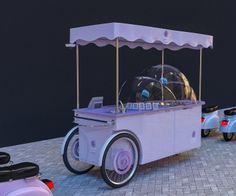 an ice cream cart sitting on top of a brick road next to parked scooters