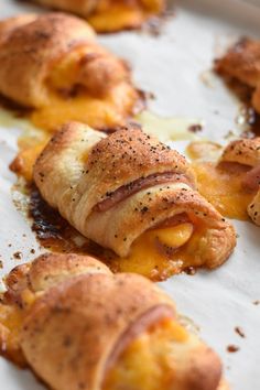 some food that is laying out on a tray with cheese and other things in it