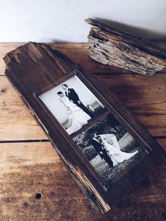 an old wooden frame with two photos in it on top of a table next to a piece of driftwood