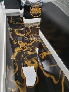 black and yellow marble flooring with white trim