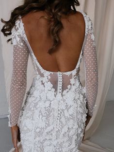 the back of a woman's white wedding dress