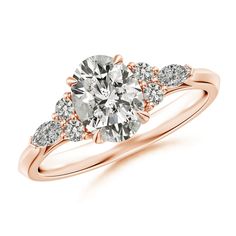 a rose gold engagement ring with three stones on the band and an oval center stone