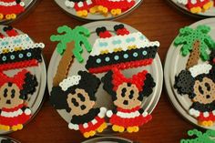 many mickey mouse cupcakes are decorated in the shape of boats and palm trees