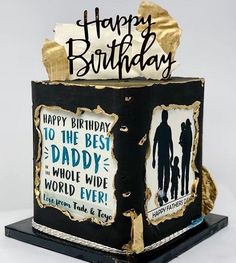 a black and gold birthday cake with the words happy birthday on it's side