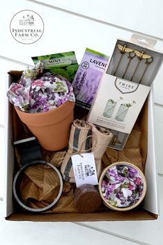 an open box containing flowers, candles and other items